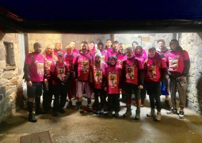 a team shot of approximately 20 people all wearing pink fundraising tops for the mount snowden challenge organised by seven hair and body