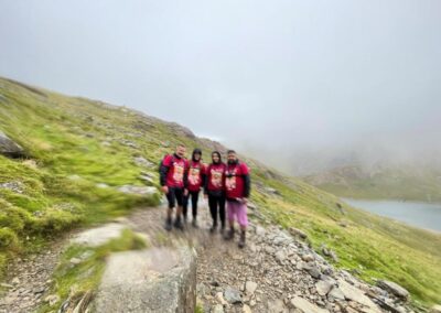 a blurred image of four people walking up mount snowden